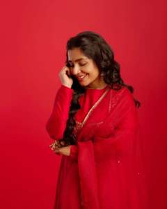 rajisha-vijayan-in-vibrant-red-full-sleeve-flared-Anarkali-styling-with-Traditional-gold-jhumkas-and-statement-rings-photos-005