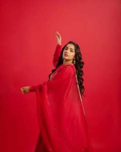 rajisha-vijayan-in-vibrant-red-full-sleeve-flared-Anarkali-styling-with-Traditional-gold-jhumkas-and-statement-rings-photos-006