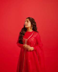 rajisha-vijayan-in-vibrant-red-full-sleeve-flared-Anarkali-styling-with-Traditional-gold-jhumkas-and-statement-rings-photos-007