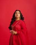 rajisha-vijayan-in-vibrant-red-full-sleeve-flared-Anarkali-styling-with-Traditional-gold-jhumkas-and-statement-rings-photos-001