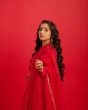 rajisha-vijayan-in-vibrant-red-full-sleeve-flared-Anarkali-styling-with-Traditional-gold-jhumkas-and-statement-rings-photos-003