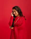 rajisha-vijayan-in-vibrant-red-full-sleeve-flared-Anarkali-styling-with-Traditional-gold-jhumkas-and-statement-rings-photos-005