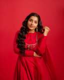 rajisha-vijayan-in-vibrant-red-full-sleeve-flared-Anarkali-styling-with-Traditional-gold-jhumkas-and-statement-rings-photos