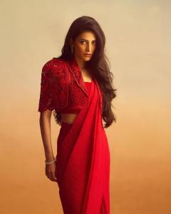 shruti-haasan-in-Crimson-Red-Western-Fusion-Saree-paired-with-a-structured-cut-out-embroidered-cropped-lace-cape-or-jacket