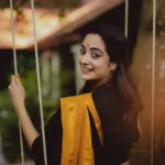 namitha pramod in black saree with orange border dress photos