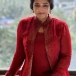anu sithara in wine red overcoat with long dress photo
