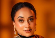 pearle maaney in Deep V neckline embroidery blouse with Sheer black organza saree Black velvet band choker centered with a gold circular photos