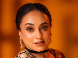 Pearle Maaney pearle maaney in Deep V neckline embroidery blouse with Sheer black organza saree Black velvet band choker centered with a gold circular photos