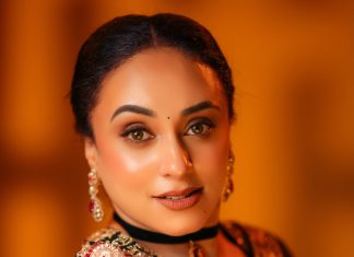 pearle maaney in Deep V neckline embroidery blouse with Sheer black organza saree Black velvet band choker centered with a gold circular photos