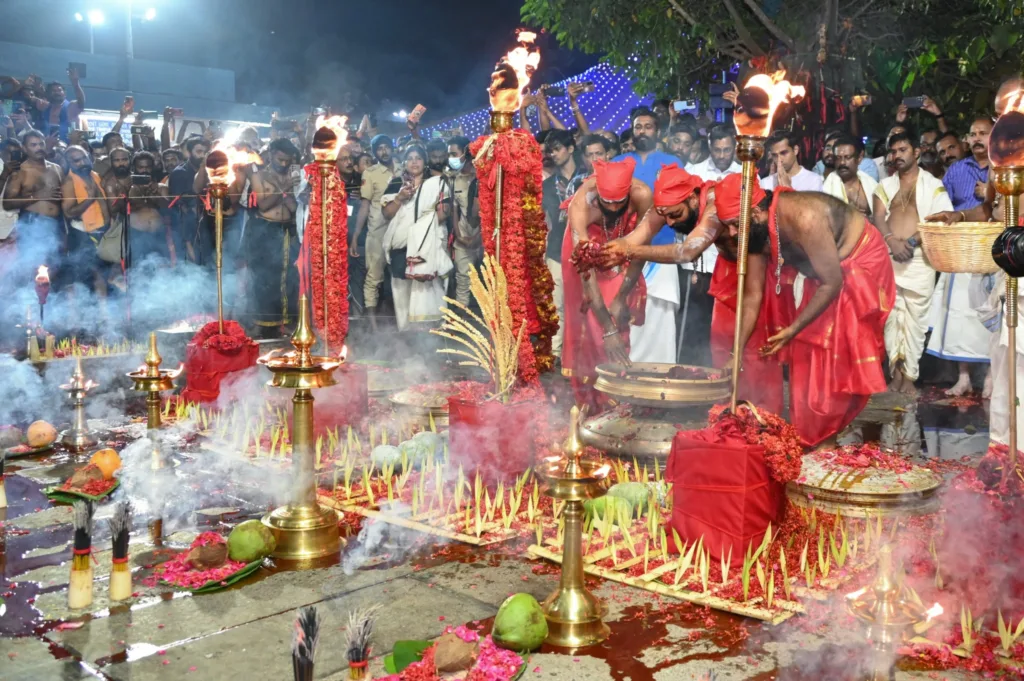 Priests performing Sabarimala Guruthi Pooja ritual with 64 kallams and oil lamps