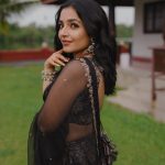 Actress Rajisha Vijayan A fitted sleeveless V neck crop top and dark Lehenga photos