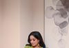 kavya madhavan in Soft wavy hair styled open paired with dangling ethnic earrings and a small blue bindi on her forehead photos