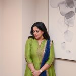 kavya madhavan in Soft wavy hair styled open paired with dangling ethnic earrings and a small blue bindi on her forehead photos