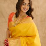 namitha pramod in bright sunny yellow silk saree with contrasting solid coral orange silk blouse with plain short sleeves and a scoop neck