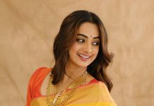 namitha pramod in bright sunny yellow silk saree with contrasting solid coral orange silk blouse with plain short sleeves and a scoop neck