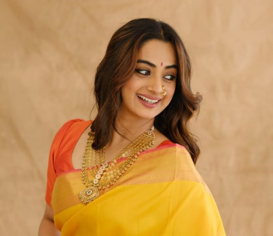 Namitha Pramod namitha pramod in bright sunny yellow silk saree with contrasting solid coral orange silk blouse with plain short sleeves and a scoop neck