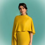 samantha ruth prabhu wearing a mustard yellow chartreuse ensemble featuring a high neckline and a draped cape like overlay that flows over her shoulders and down the right side of the dress