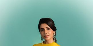 samantha ruth prabhu wearing a mustard yellow chartreuse ensemble featuring a high neckline and a draped cape like overlay that flows over her shoulders and down the right side of the dress