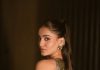 saniya iyappan in high waisted floor length skirt with sleeveless halter style crop top in shimmering metallic gold brocade fabric