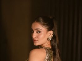 saniya iyappan in high waisted floor length skirt with sleeveless halter style crop top in shimmering metallic gold brocade fabric