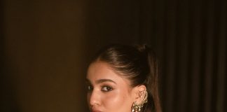 saniya iyappan in high waisted floor length skirt with sleeveless halter style crop top in shimmering metallic gold brocade fabric