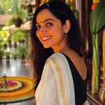 Actress lighting Nilavilakku in Kasavu saree Onam photoshoot