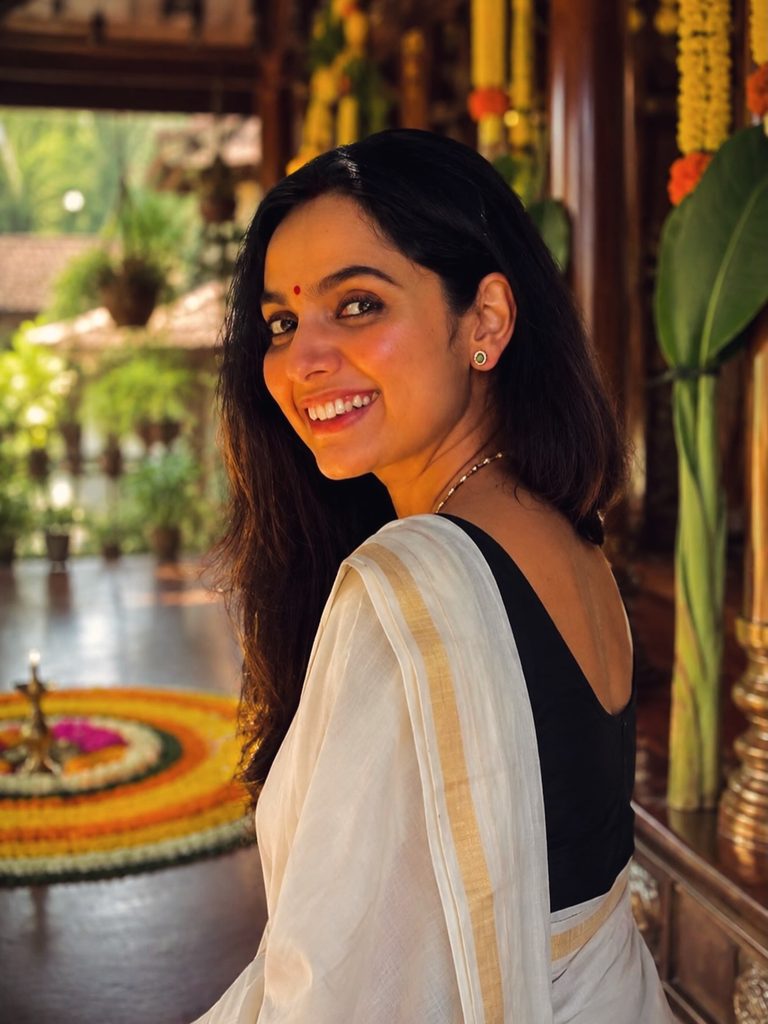 Actress lighting Nilavilakku in Kasavu saree Onam photoshoot