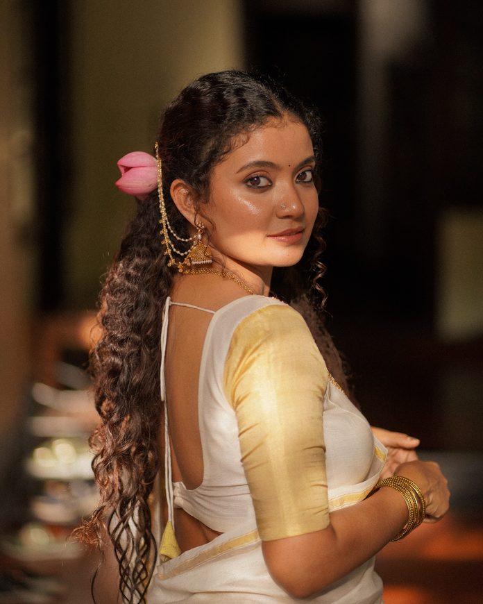 Side profile candid glance in traditional Kerala saree