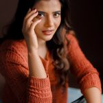 aishwarya rajesh in rust orange terracotta long sleeved sweater with relaxed fit blue jeans with heavy knee distressing pics