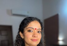 anna ben in red simple kara set and mundu kerala traditional dress and makeup pics