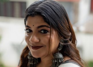 aparna balamurali in classic off white traditional saree embellished with delicate red polka dot motifs and a contrasting black border photos