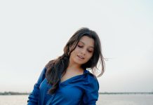 niranjana anoop in vibrant royal blue long sleeved button down shirt and High waisted wide leg dark wash jeans photos