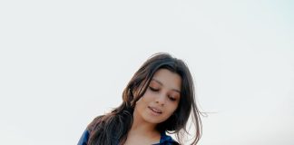Niranjana Anoop niranjana anoop in vibrant royal blue long sleeved button down shirt and High waisted wide leg dark wash jeans photos