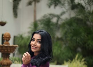 rajisha vijayan in deep purple long Anarkali kurta featuring a high round neck full length fitted sleeves dress photos