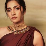 rukmini vasanth in Deep Wine Draped Indo Western Gown Styled with a chunky traditional gold choker set with blue accents photos