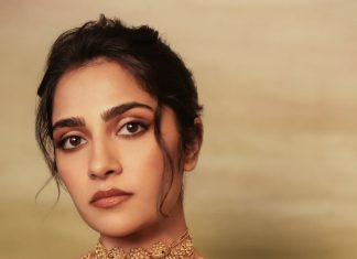 rukmini vasanth in Deep Wine Draped Indo Western Gown Styled with a chunky traditional gold choker set with blue accents photos