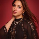 tamanna in floor length black gown featuring a high mock neckline and an intricate sheer lace bodice panel design outfit