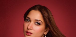 Tamanna Bhatia tamanna in floor length black gown featuring a high mock neckline and an intricate sheer lace bodice panel design outfit
