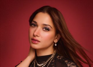 tamanna in floor length black gown featuring a high mock neckline and an intricate sheer lace bodice panel design outfit