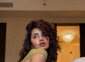 anupama parameswaran in Olive green sleeveless fitted crop top with Light wash denim jeans Features standard belt loops silver button or rivet hardware style photos