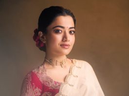 Rashmika Mandanna rashmika mandanna in cream colored saree with pink long sleeved blouse adorned with rich intricate gold paisley and floral embroidery design photos